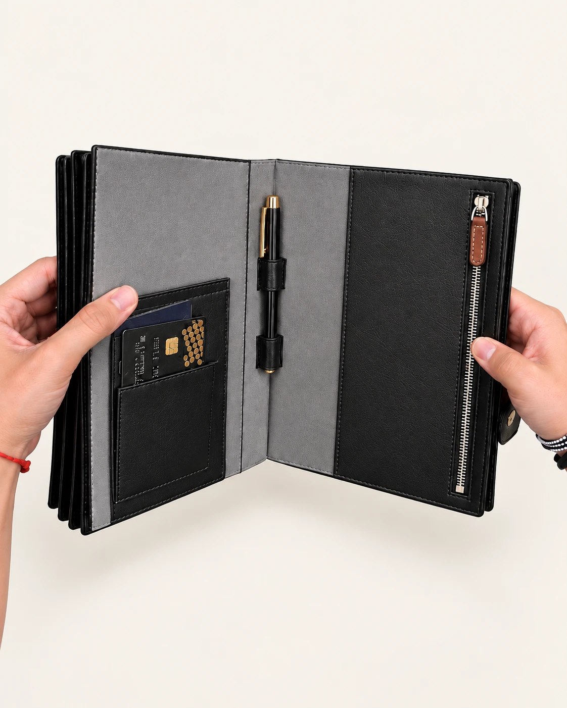The NOVAIR folio held open: card slot with a bank card, pen loop with a gold-trimmed pen, and the zip pocket